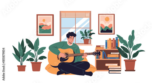 Young man sits comfortably in his cozy plant-filled living room playing a beautiful acoustic guitar for relaxation and fun.