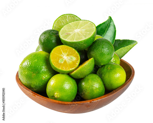 A wooden bowl holds fresh, halved calamansi and limes, highlighting their juicy, vibrant freshness.