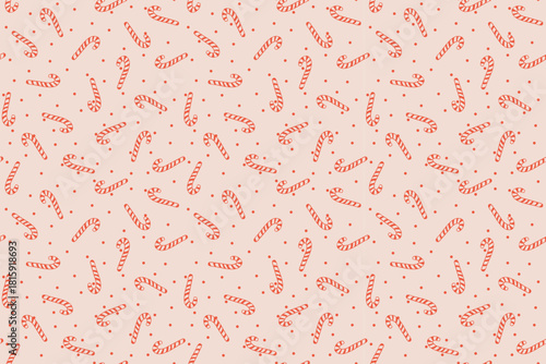 hand-drawn doodle seamless pattern featuring red striped candy canes and polka dots on a pastel pink background. Perfect for textile, fabric, wrapping paper, backgrounds, product packaging, and print 