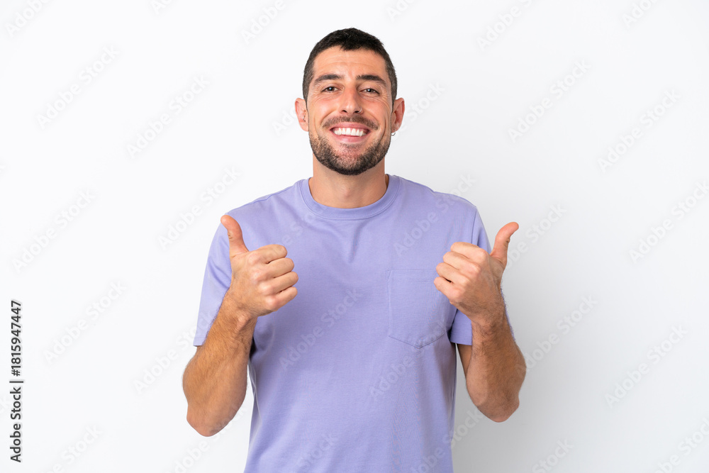 Fototapeta premium Young handsome caucasian man isolated on white background with thumbs up gesture and smiling