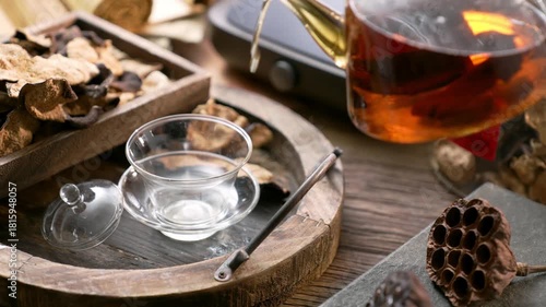 Traditional Chinese Tea Ceremony with Glass Teapot Cup and Chenpi Herbal Ingredients on Wooden Tray