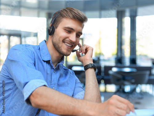 Smiling friendly handsome young male call centre operator