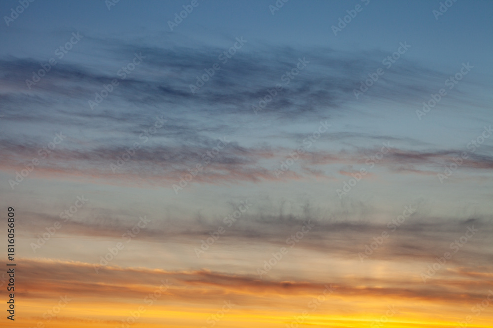 Obraz premium skyscape and cloudscape of blue and grey streaked sky with white and golden yellow sunset with space for copy and titles Scotland UK