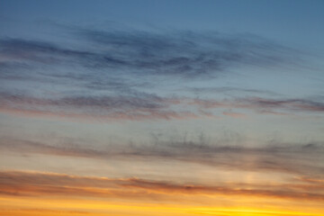 Fototapete Sonnenuntergang skyscape and cloudscape of blue and grey streaked sky with white and golden yellow sunset with space for copy and titles Scotland UK  © Lee Karen Stow