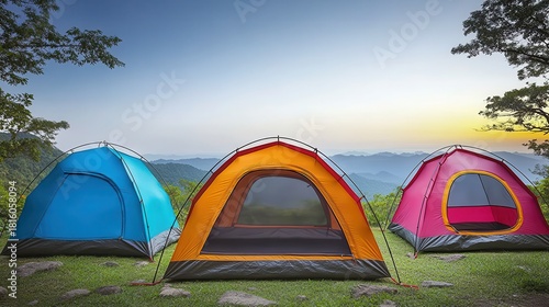 Wallpaper Mural Outdoor camping tents set up on a grassy hillside with rolling mountains under a bright sky at sunset Torontodigital.ca