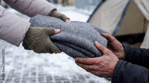 Volunteer giving warm clothes to homeless person hands sweater winter donation charity poverty help support humanitarian aid cold weather kindness social work textile sharing community service 