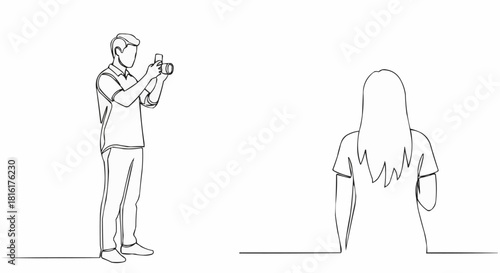 Man taking a photo of a woman from behind.