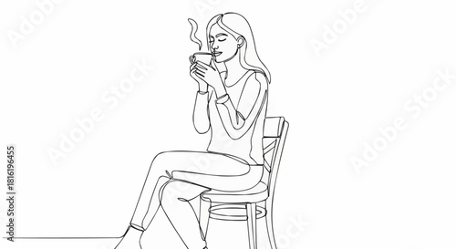 Woman enjoying a warm beverage while seated in a chair, relaxing.