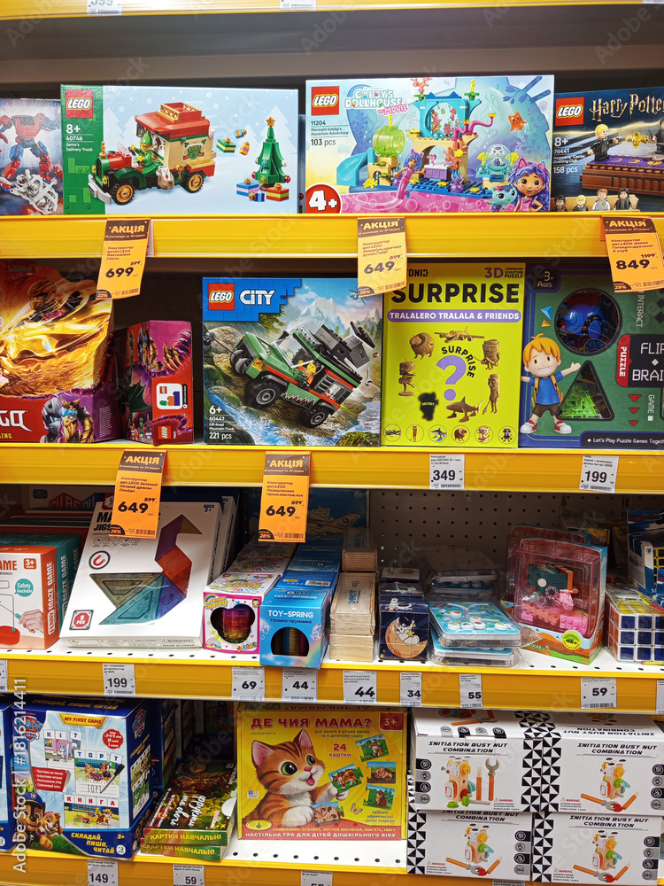 Naklejka premium Zvyagel, Ukraine - November 20, 2025: Colorful display of various LEGO sets on store shelves, featuring popular themes like Harry Potter and city adventures, showcasing creativity and playfulness