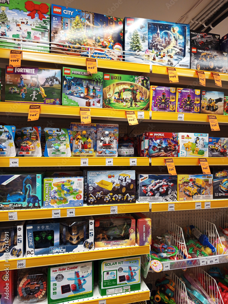 Fototapeta premium Zvyagel, Ukraine - November 20, 2025: Colorful display of LEGO toy sets in a retail store, showcasing various themes like City, Fortnite, and Minecraft, perfect for children's creativity and playtime