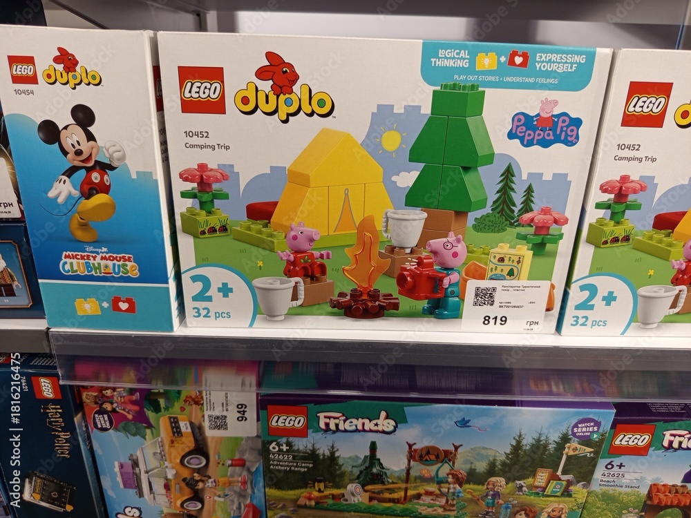 Fototapeta premium Zvyagel, Ukraine - November 20, 2025: LEGO Duplo Peppa Pig Camping Trip set displayed on store shelf, featuring colorful pieces and engaging design for young childrens playtime