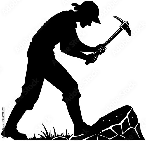 Silhouette of Worker Using Pickaxe on Rock