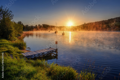 Frymburk on the shore of the Lipno dam at sunrise with fog
