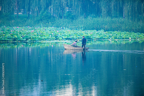 Photography Tangshan City, Hebei Province, China - July 11, 2024: A fisherman drives a small