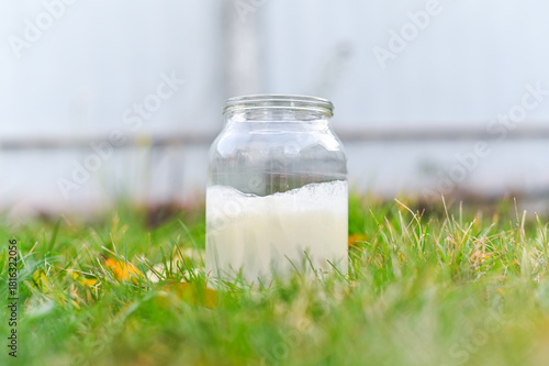 A glass jar with non-homogenized, whole milk