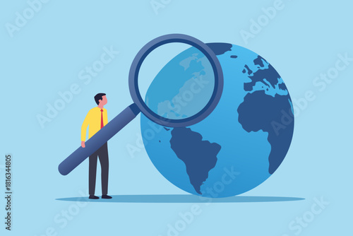 Global analysis businessman examining the world with a magnifying glass for opportunities