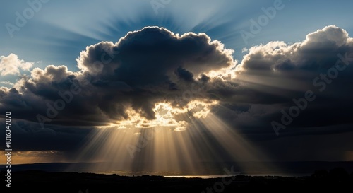 Golden Sunbeams Bursting Through Dramatic Storm Clouds Over Scenic Landscape