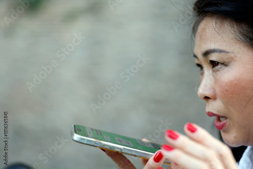 Bild auf Leinwand Close portrait of concentrated user dictating voice message on phone