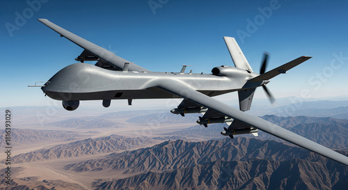 Grey military uav with missiles flying over desert mountains during combat patrol mission