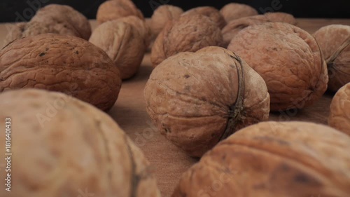 Walnut close up on a wooden table. Walnut close up. product rich in minerals and vitamins. Walnut turns in a shot.
