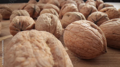 Walnut close up on a wooden table. Walnut close up. product rich in minerals and vitamins. Walnut turns in a shot.