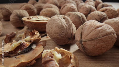 Walnut close up on a wooden table. Walnut close up. product rich in minerals and vitamins. Walnut turns in a shot.