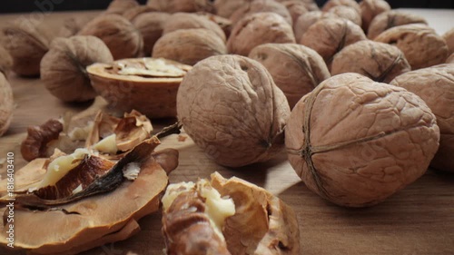 Walnut close up on a wooden table. Walnut close up. product rich in minerals and vitamins. Walnut turns in a shot.