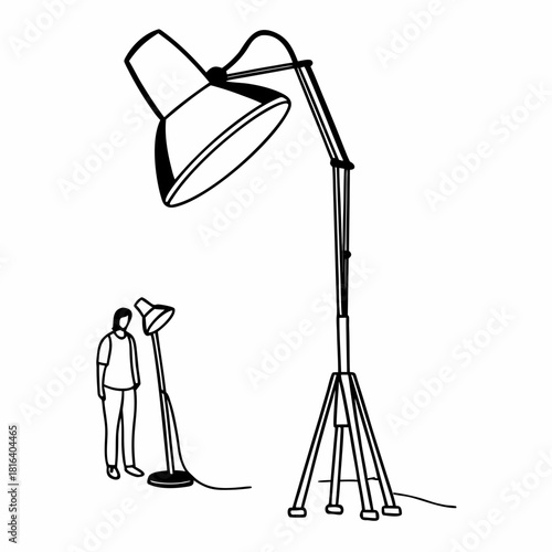 A person stands next to a small lamp while a giant floor lamp looms large