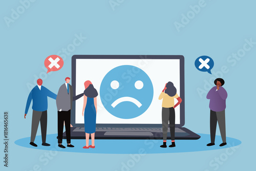 Diverse group of people react to negative feedback on a laptop screen with sad face emoji