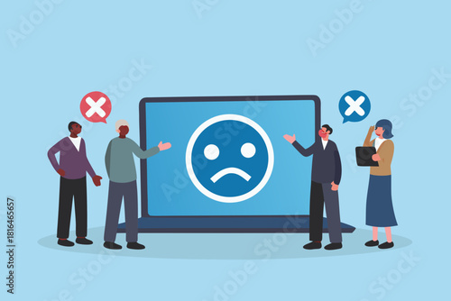 Diverse group of people reacting to negative feedback on a laptop screen displaying a sad face icon