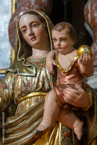 Statue (19th century) of Blessed Virgin Mary holding baby Jesus Christ in her arms.