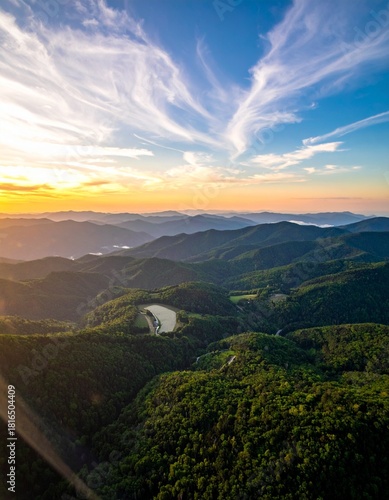 Wallpaper Mural Aerial shot of green mountains with lake and golden sunset in bright sunny day in Appalachian mountains in United States of America in summer is showing amazing mountain view Torontodigital.ca