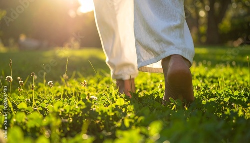 Bare Feet Walking on Lush Green Grass in White Linen Pants