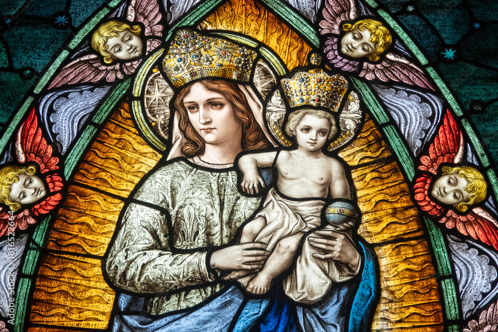 Fototapeta premium Stained glass (19th century) of Blessed Virgin Mary holding baby Jesus Christ in her arms.