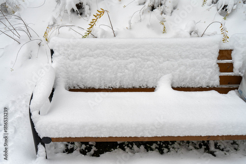 Wallpaper Mural Bench completely buried under thick snow after heavy snowfall, quiet winter urban park scene with deep snow cover and frozen outdoor atmosphere Torontodigital.ca