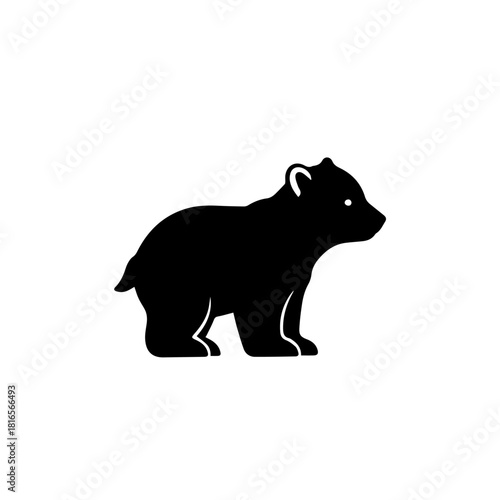 A black silhouette of a small bear cub standing on a white background, looking to the right.