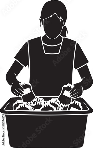 Silhouette of a woman washing clothes in a basin with her hands scrubbing fabric clean
