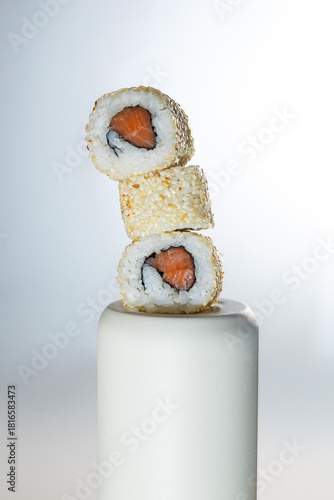 Sushi roll with salmon and rice on light background