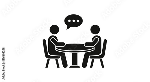 Simple black icon of two people having a conversation or meeting at a round table, representing discussion, interview, or consultation