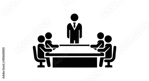 A simple black and white icon depicting a business meeting in a boardroom, with a leader presenting to a team sitting around a conference table