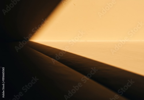 High contrast abstract background featuring a sweeping, blurred dark shadow line against a bright, warm backdrop. A study in sunlight and subtle texture ,background ,negative space ,design