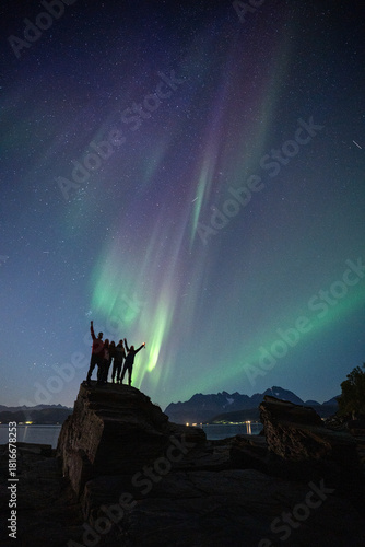 Couple enjoying a night under the Northern Lights in Tromso, Norway