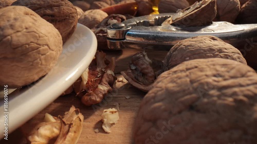 Walnuts with nutcracker on wooden table close up.