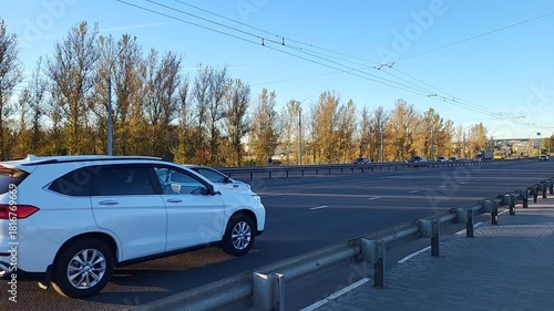 On a sunny autumn day, traffic on the city highway