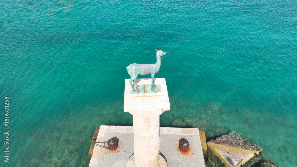 Naklejka premium Aerial drone photo of iconic Doe statue in entrance of Mandraki harbor where Colossus of Rhodes island was standing, Dodecanese, Greece