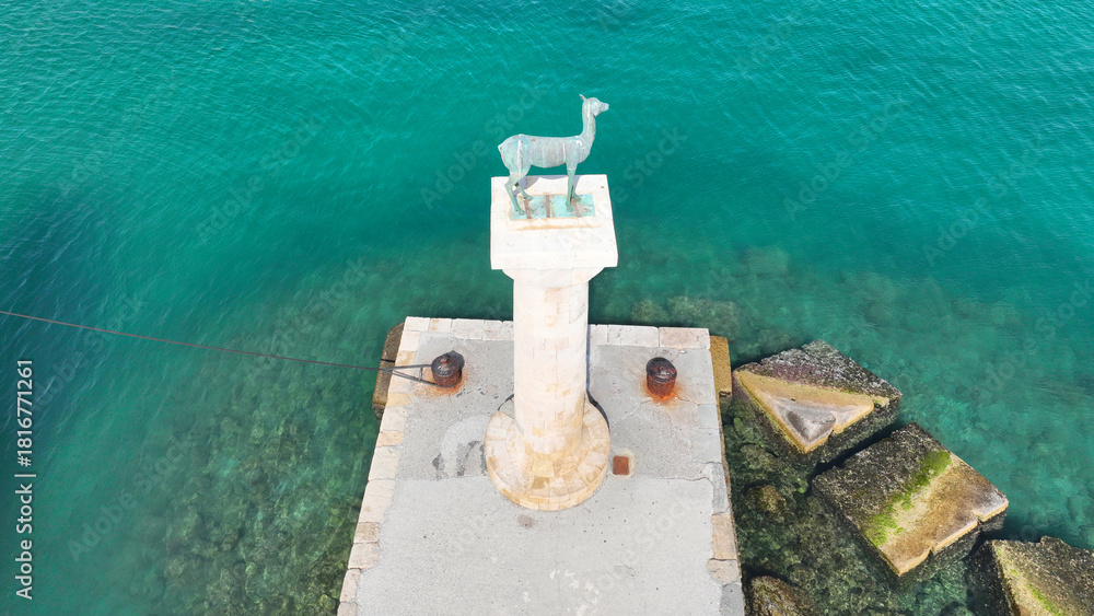 Naklejka premium Aerial drone photo of iconic Doe statue in entrance of Mandraki harbor where Colossus of Rhodes island was standing, Dodecanese, Greece