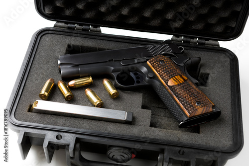 Automatic gun and bullets in a plastic hard case on white background