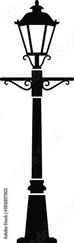 Classic black silhouette of an ornate vintage street lamp post with a decorative top and base isolated on a clean white background symbolizing old world charm and illumination