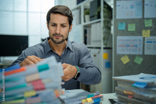 Worried businessman with insomnia working overtime on important documents. Shows depression, pressure, and business technology stress.
