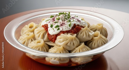 Delicious dumplings dish with sauce herbs and cream in a glass bowl